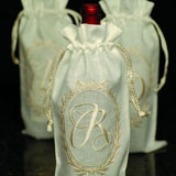 Oval monogram embroidered cream linen wine bags | Gracious Style